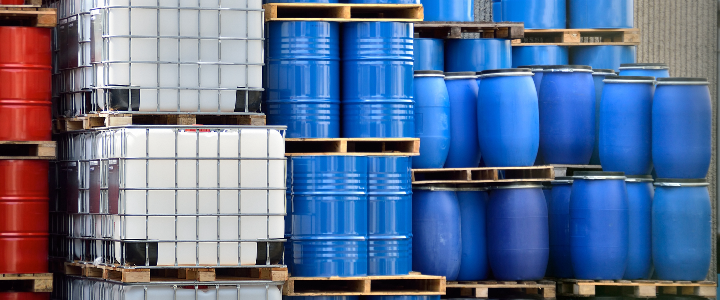 Stacked colorful containers in a large delivery warehouse