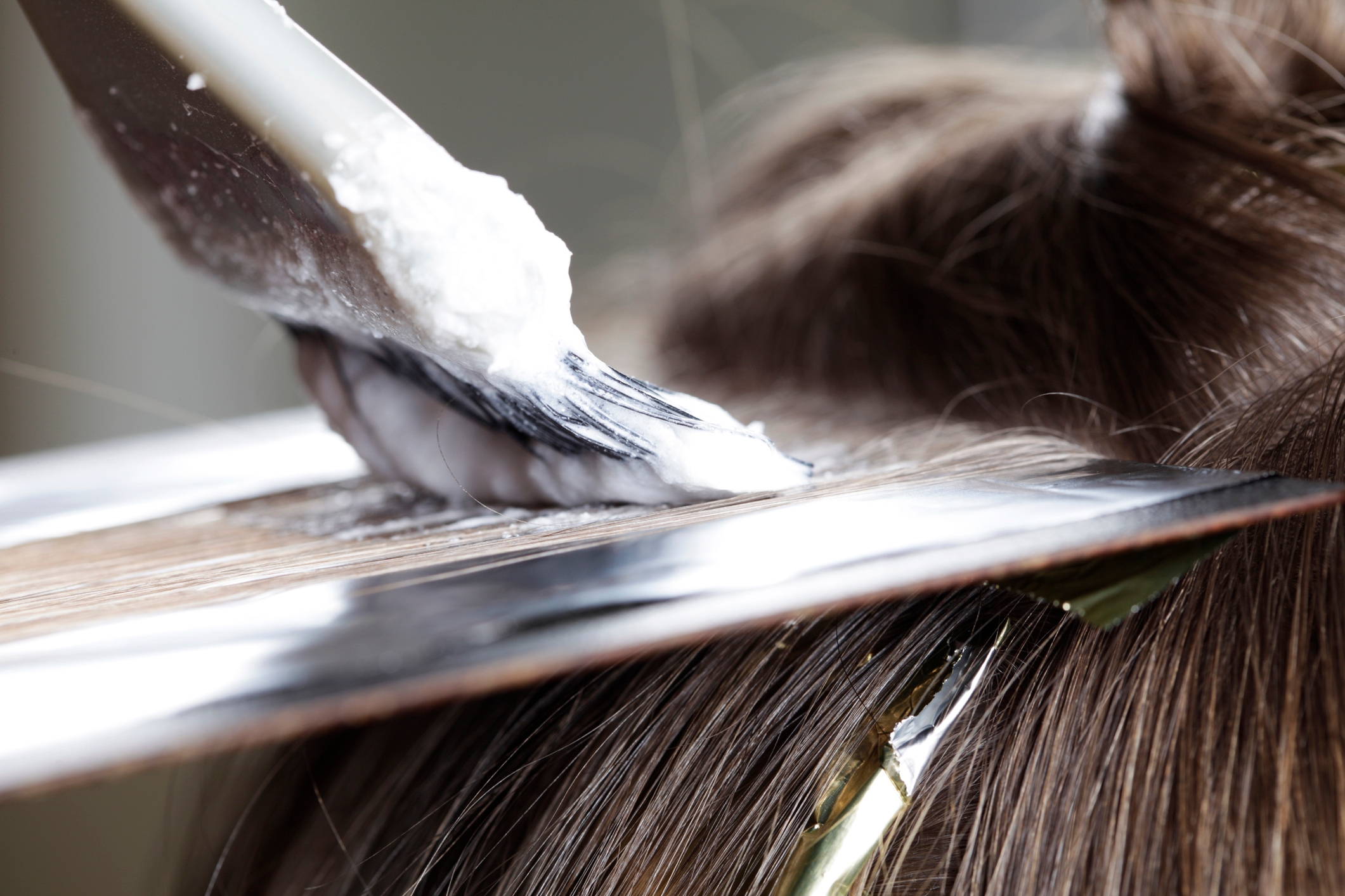 At the hairdresser. Close-up of highlights with foil.